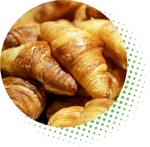 A close-up of croissants in a circular frame.